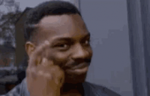 A meme of a cool guy typing the side of his temples three times while smiling